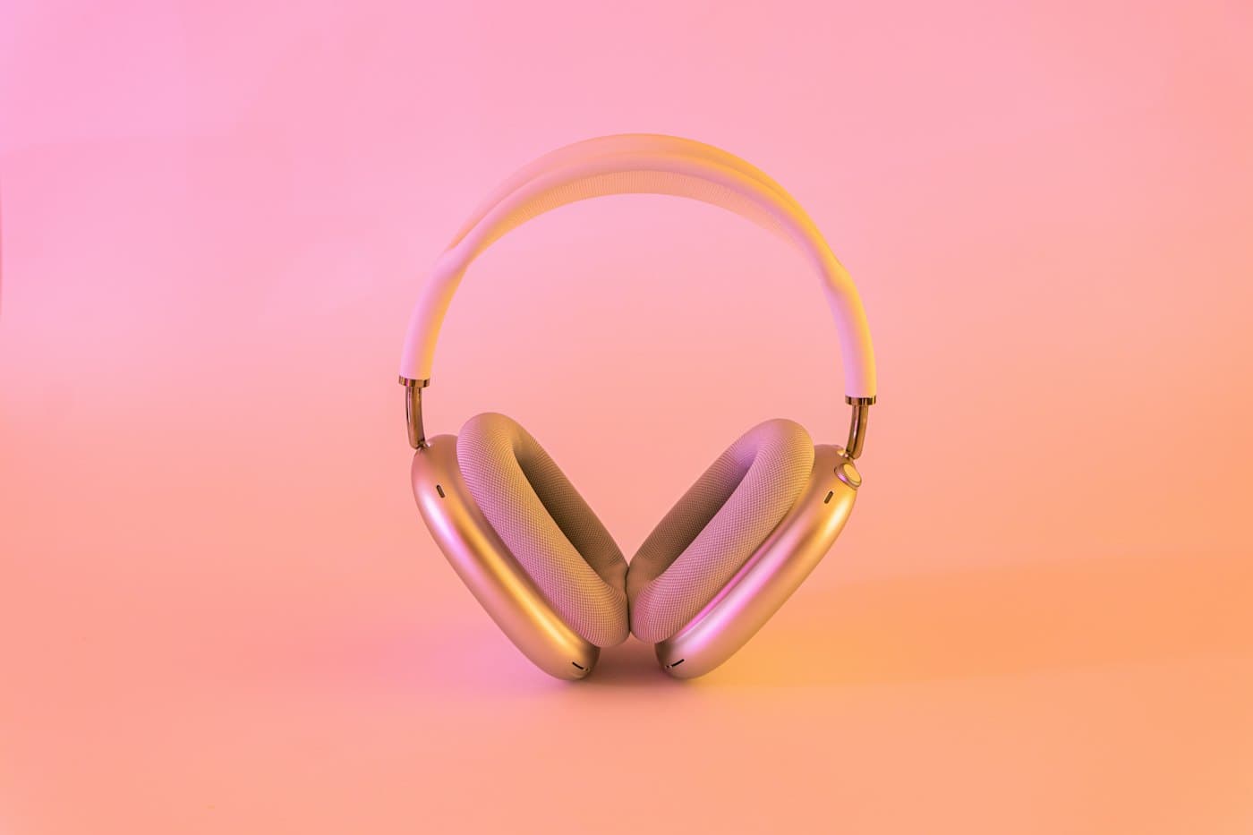 Pink over-ear headphones on a pink background