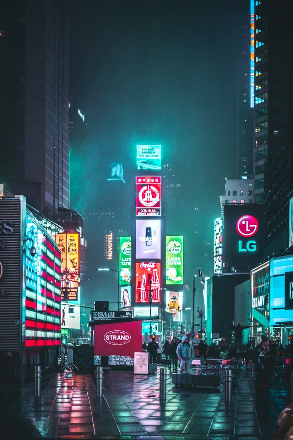 Neon signs glowing over a city street at night